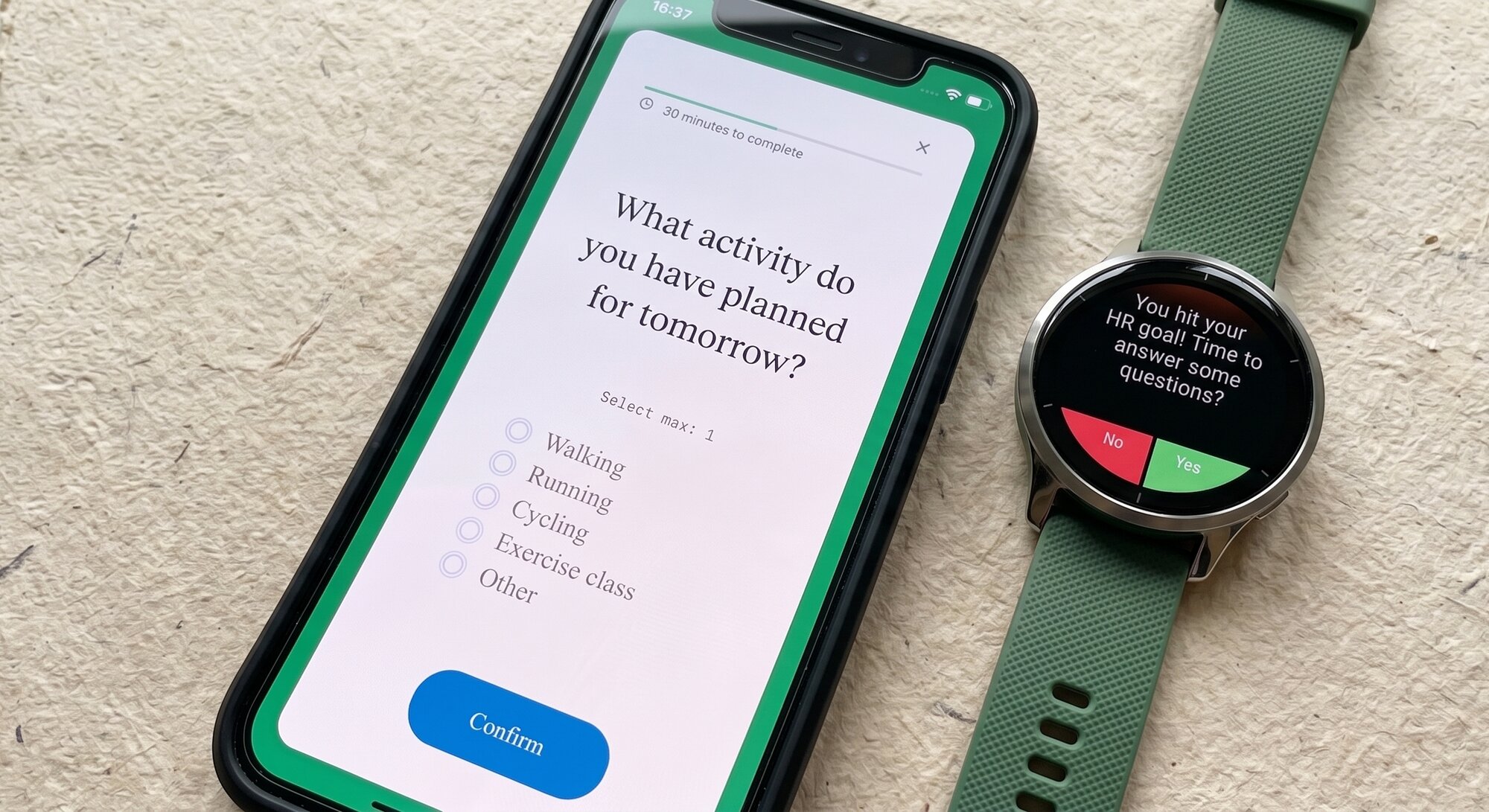 Fitabase Engage mobile app and Garmin smartwatch shown on a warm editorial flat lay